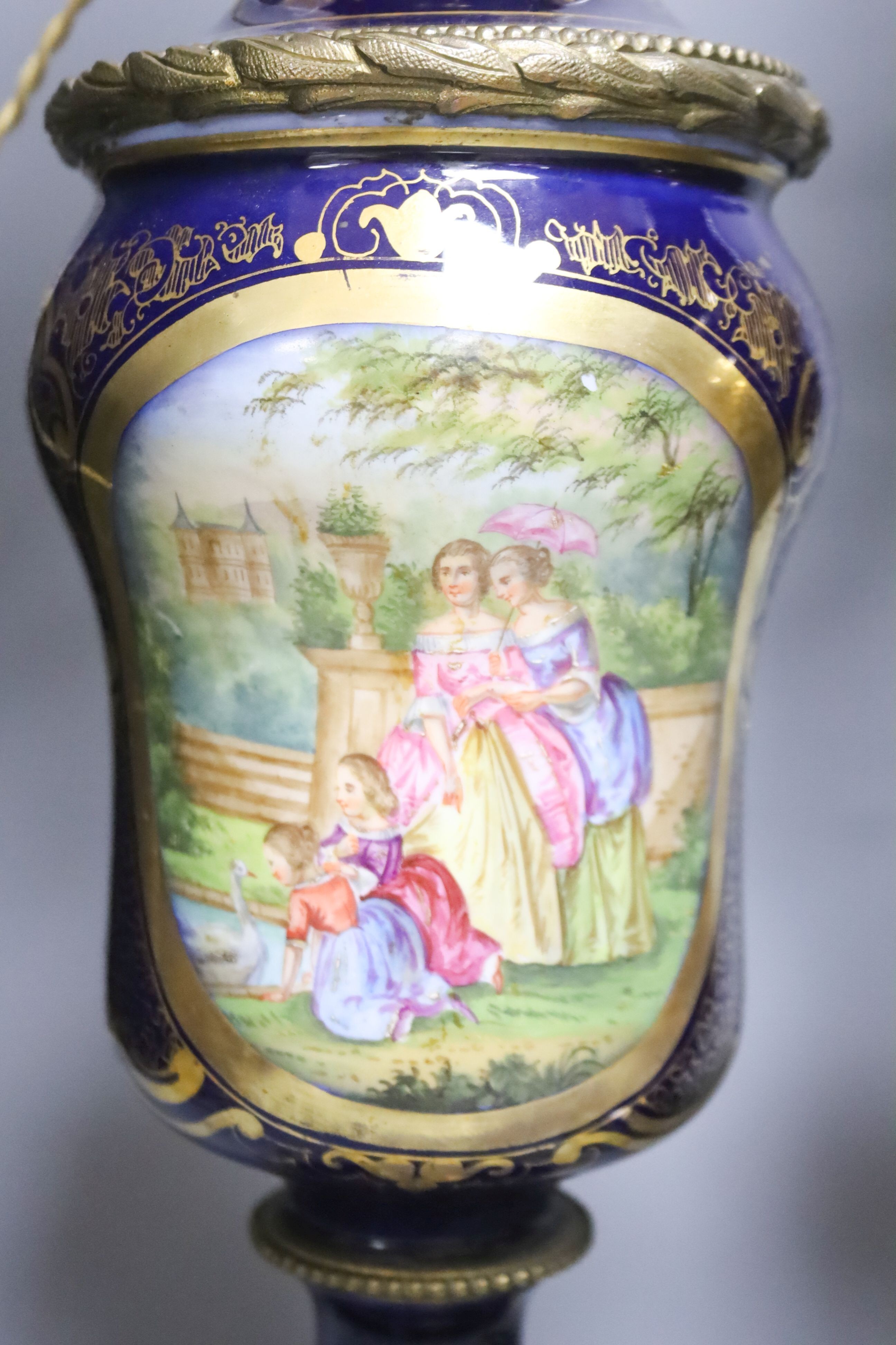 A matched pair of hand-painted Paris porcelain converted oil lamps 57cm